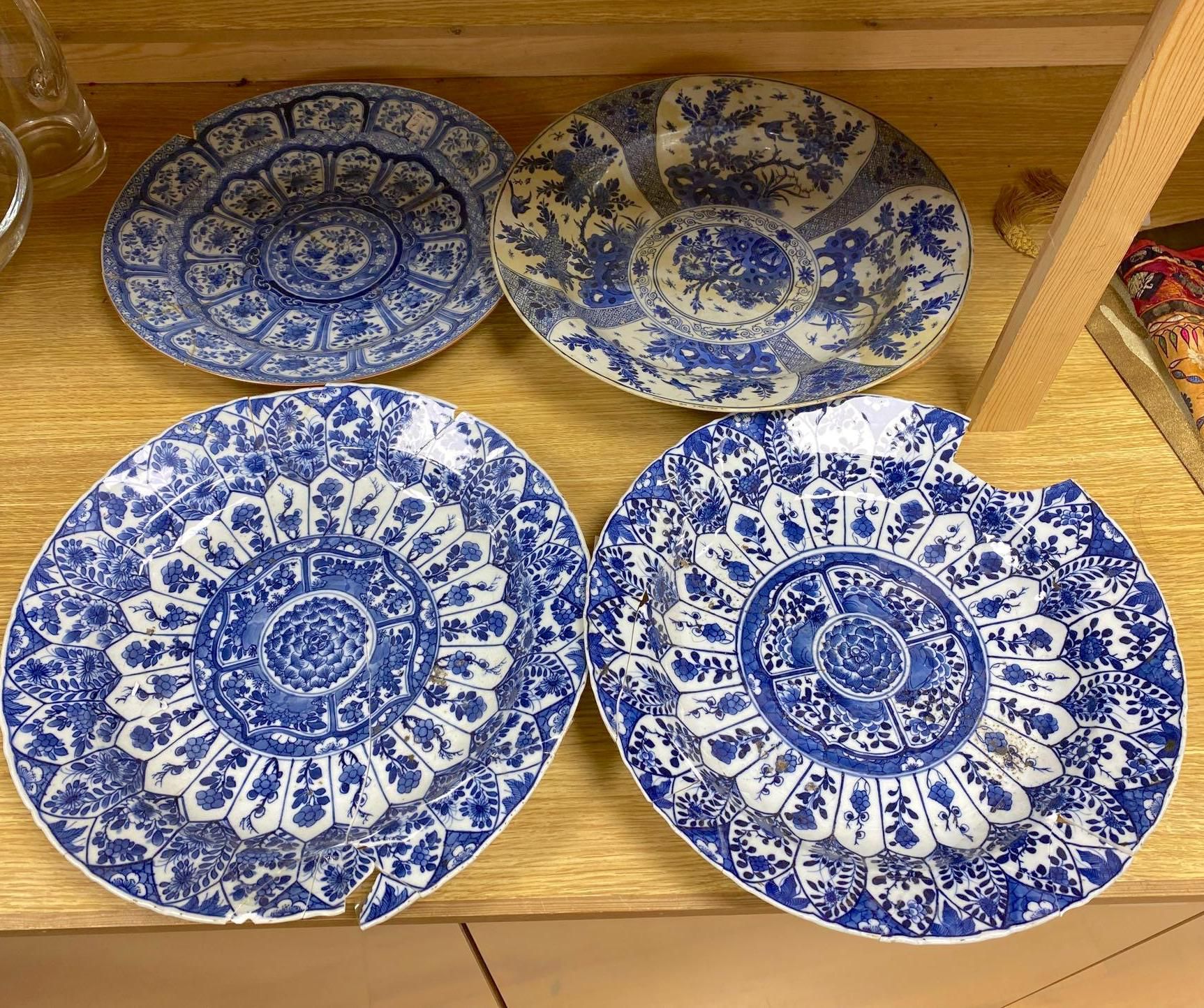 Four Chinese Kangxi period blue and white dishes and a Qianlong blue and white dish